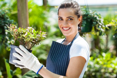 Team trimming hedges in Turnham Green with recycling bins visible